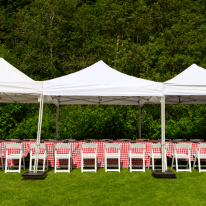 Outdoor event setup with white tents.