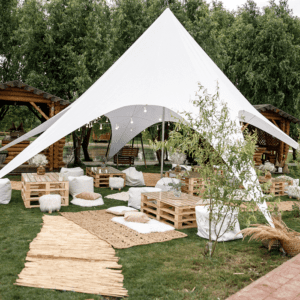 Outdoor event setup with white canopy tent.