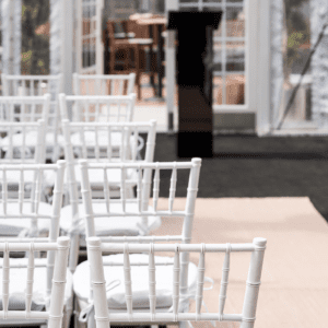 White chairs arranged for an outdoor event.
