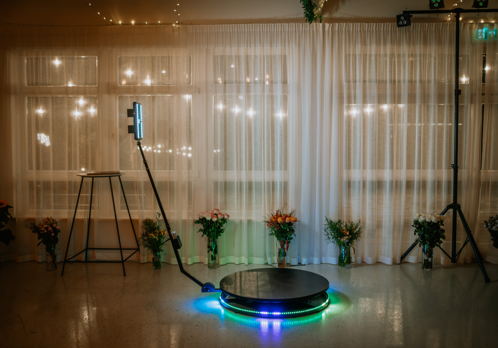 Photo booth with lights and flowers setup.